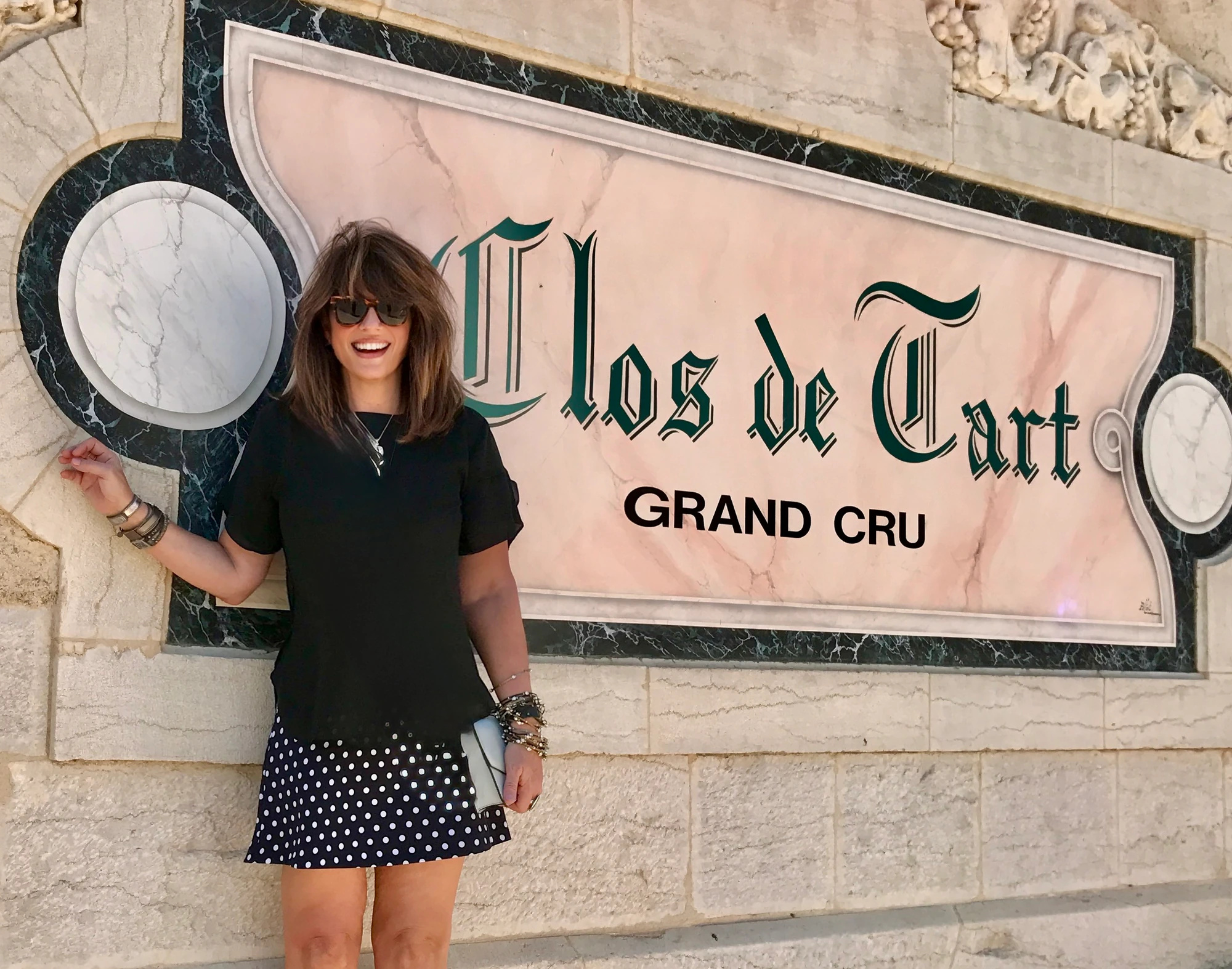 Susan standing beside the Clos du Tart Grand Cru sign