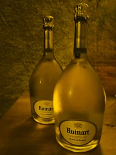 Ruinart Champagne bottles in a cellar