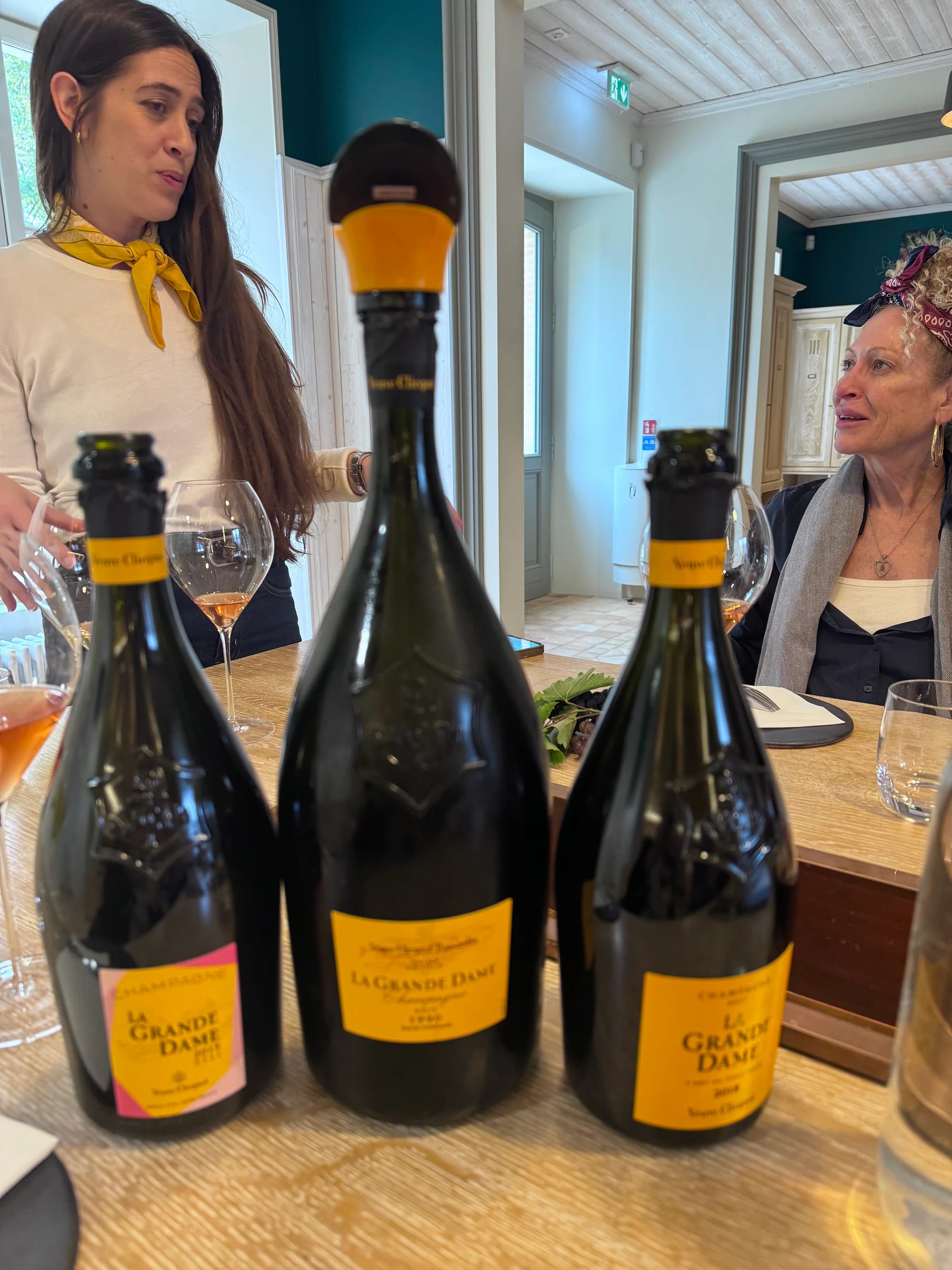 Three Champagne bottles at a tasting
